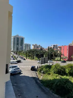 a city street with cars parked in a parking lot at Dora Family Apartments Budva in Budva