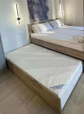 two beds sitting next to each other in a bedroom at Dora Family Apartments Budva in Budva
