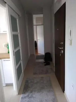a hallway with a room with a door and a room with a hallwayngthngth at Main bus station apartment in Podgorica