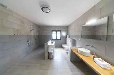 a large bathroom with two toilets and a sink at Villa Mattson in Budva