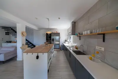 a kitchen with a long counter in a room at Villa Mattson in Budva