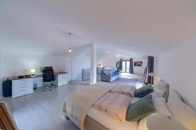 a bedroom with a large bed and a desk at Villa Mattson in Budva