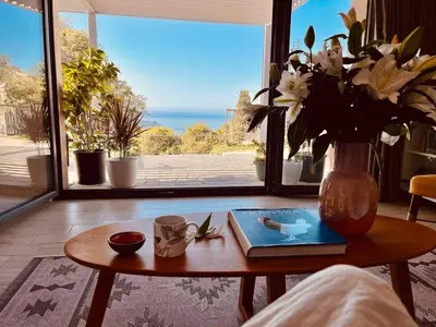 a living room with a table with a vase of flowers at Villa Mattson in Budva