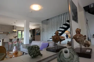 a living room with a white couch and a staircase at Villa Mattson in Budva