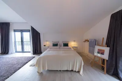 a bedroom with a large bed and a large window at Villa Mattson in Budva