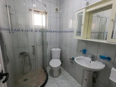 a bathroom with a shower and a toilet and a sink at Villa Erik in Ulcinj