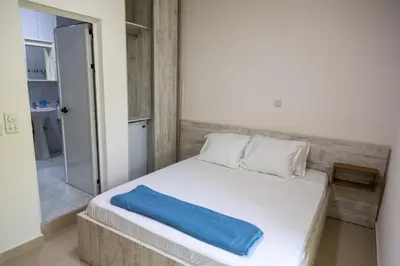 a bedroom with a bed with a blue pillow on it at Villa Erik in Ulcinj