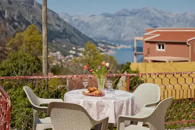 a table with a plate of food and flowers on it at DREAM S&L in Kotor