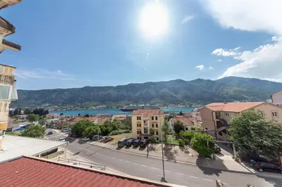 a view of a town with a river and mountains at Sailor's Knot Apartment - Central and Amazing Sea View in Kotor