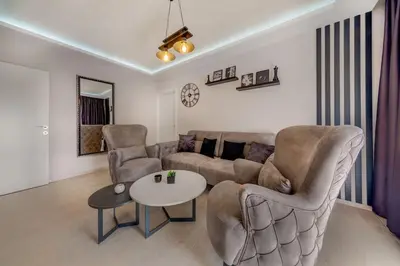 a living room with a couch and chairs and a table at Sailor's Knot Apartment - Central and Amazing Sea View in Kotor