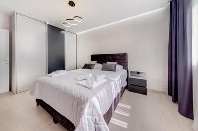 a bedroom with a large white bed in a room at Sailor's Knot Apartment - Central and Amazing Sea View in Kotor