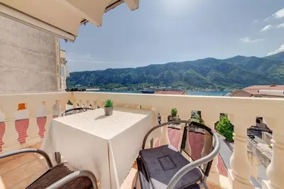 a table and chairs on a balcony with a view at Sailor's Knot Apartment - Central and Amazing Sea View in Kotor
