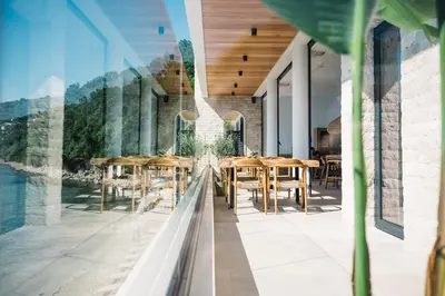 a restaurant with tables and chairs on a balcony at KAAB Boutique Hotel in Ulcinj