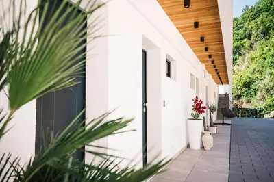 a hallway of a white building with plants at KAAB Boutique Hotel in Ulcinj