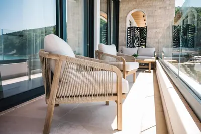 a row of chairs in a room with windows at KAAB Boutique Hotel in Ulcinj