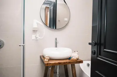 a bathroom with a sink and a mirror at KAAB Boutique Hotel in Ulcinj