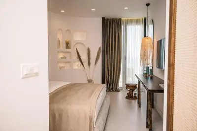 a bedroom with a bed and a desk and a window at KAAB Boutique Hotel in Ulcinj