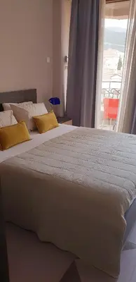a bedroom with two beds and a large window at Diva Petra Apartments in Budva