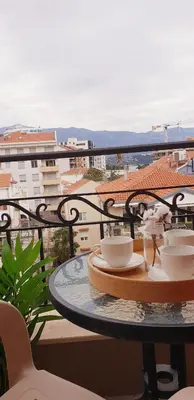 a table with plates and bowls on top of a balcony at Diva Petra Apartments in Budva