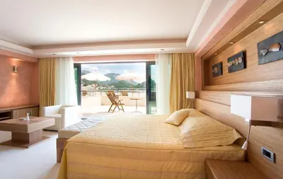 a hotel room with a bed and a balcony at Monte Casa SPA & Wellness in Petrovac na Moru