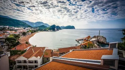 a view of a beach with buildings and the ocean at Monte Casa SPA & Wellness in Petrovac na Moru