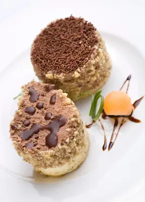 two desserts on a plate on a white plate at Monte Casa SPA & Wellness in Petrovac na Moru