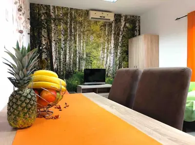 a pineapple sitting on a table with fruit on it at Apartmani LANA Podgorica in Podgorica