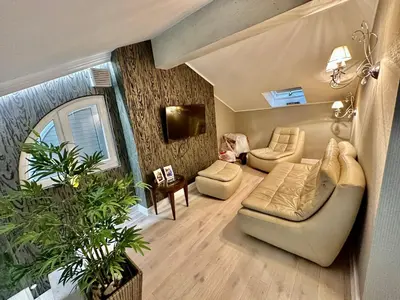 a living room with a couch and a chair at Lux Apartment Budva in Budva