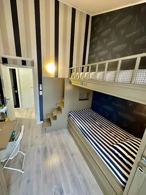 a room with two bunk beds and a desk at Lux Apartment Budva in Budva