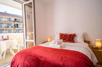 a bedroom with a red bed with towels on it at Villa Maxima Budva in Budva
