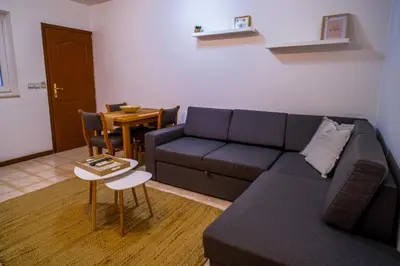 a living room with a couch and a table at Villa Maxima Budva in Budva