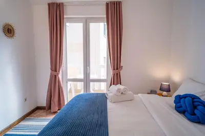 a bedroom with a bed with a teddy bear on it at Villa Maxima Budva in Budva