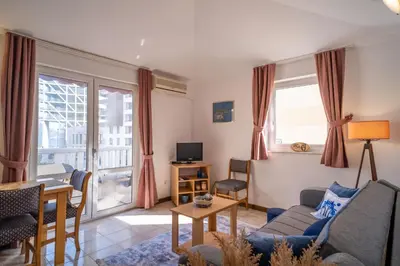 a living room with a couch and a table at Villa Maxima Budva in Budva