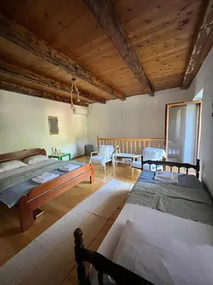 a large room with two beds and a couch at Lake Point Dodoši in Cetinje