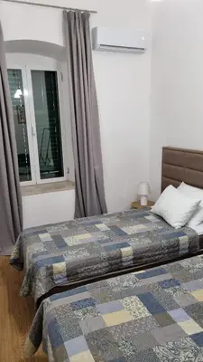 a bedroom with a bed with a quilt on it at Main Square View in Kotor
