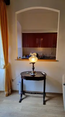 a table with a lamp on it in a kitchen at Main Square View in Kotor