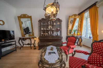 a living room filled with furniture and a chandelier at Main Square View in Kotor