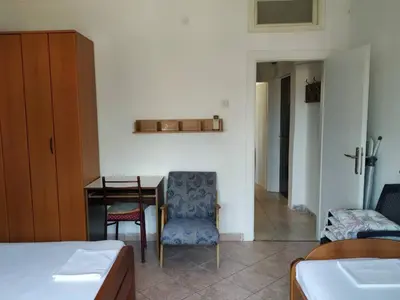 a bedroom with a desk and a chair and a table at Apartman Nadja - Sutomore in Sutomore
