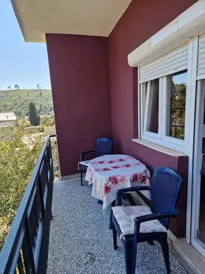 a room with a table and chairs on a balcony at Apartman Nadja - Sutomore in Sutomore