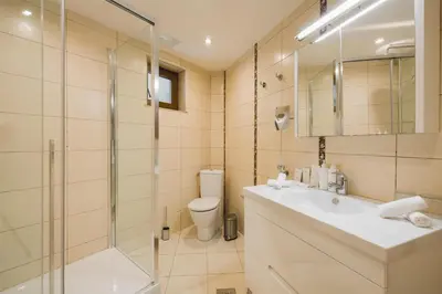 a bathroom with a toilet and a sink and a shower at Radisson Resort Ruza Vjetrova in Dobra Voda