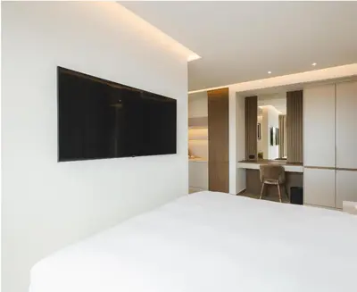 a bedroom with a flat screen tv on a white wall at Radisson Resort Ruza Vjetrova in Dobra Voda