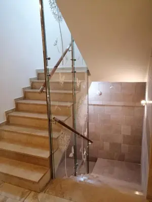 a bathroom with a shower and a glass staircase at Apartman Nora in Rafailovici