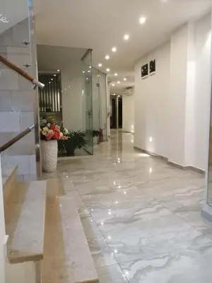 an empty lobby with a hallway with a glass door at Apartman Nora in Rafailovici