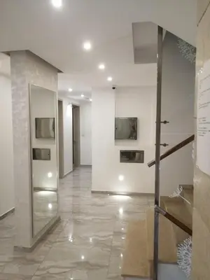 a room with a hallway with paintings on the wall at Apartman Nora in Rafailovici