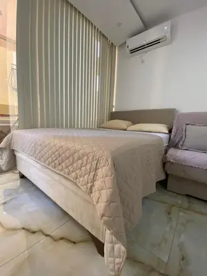 a bedroom with a bed and a couch at Apartman Nora in Rafailovici