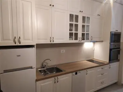 a kitchen with white cabinets and a sink at Studio Z in Podgorica