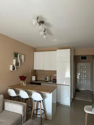 a kitchen with white cabinets and a counter top at Apartman DVA SRCA in Bar