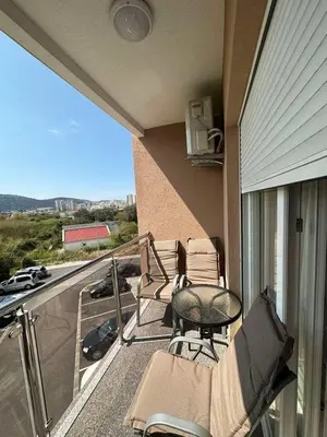 a balcony with chairs and a table on a house at Apartman DVA SRCA in Bar