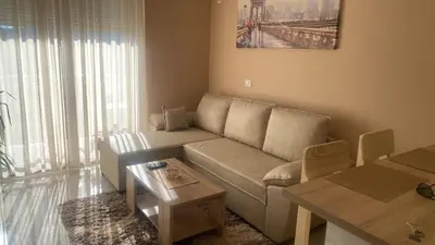 a living room with a couch and a table at Apartman DVA SRCA in Bar