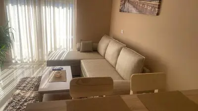 a living room with a couch and a table at Apartman DVA SRCA in Bar